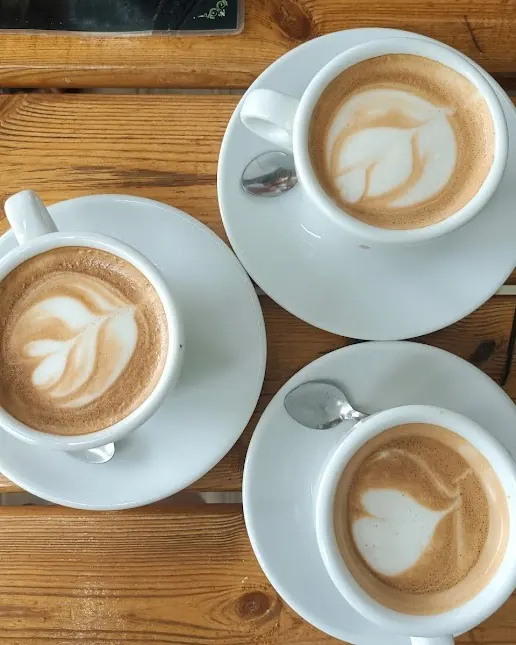 Cappuccinos with latte art on a wooden table