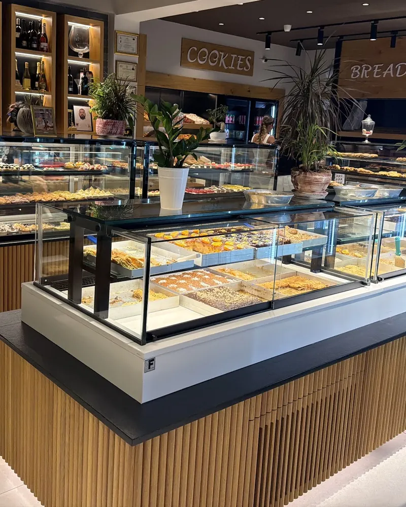 The Dolce shop floor: wooden counters and glass cases full of pastries