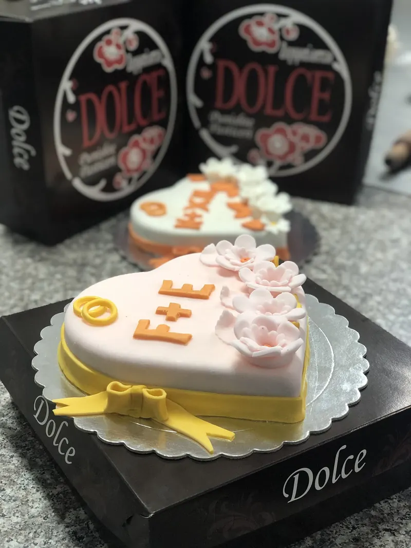 Heart-shaped celebration cake on a Dolce box