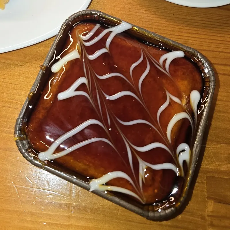 Trilece in a foil tray, glossy caramel top with white swirls